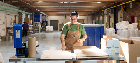 A miller packs flour orders for shipping.