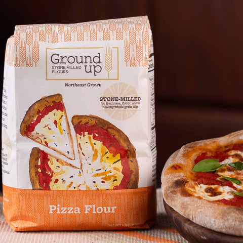 A 3 pound bag of Ground Up Pizza Flour, with a margherita pizza