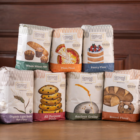 Seven bags of different varieties of Ground Up Flour